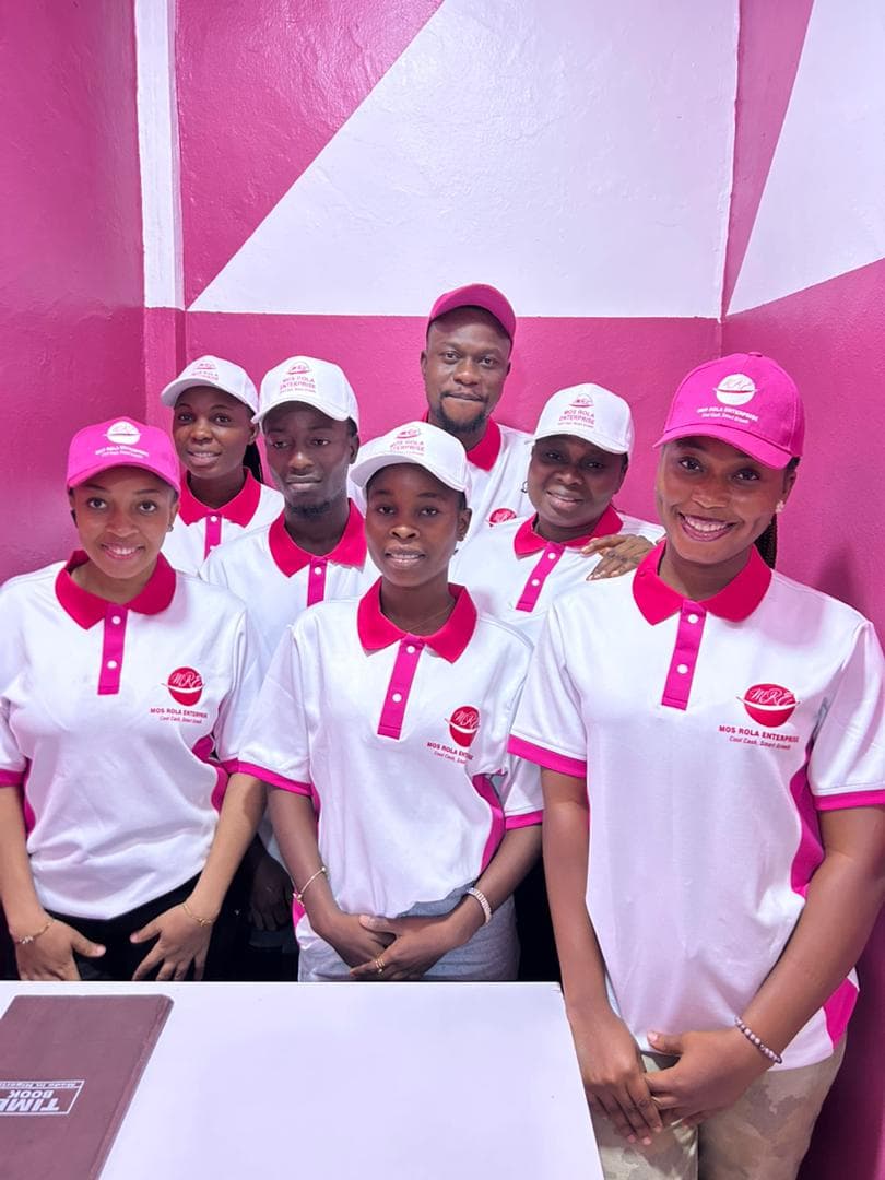 Mos Rola Enterprise team in branded uniforms at the front counter.