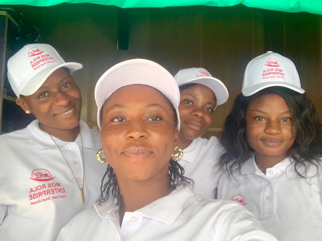 Mos Rola Enterprises team members in matching branded polos and caps.